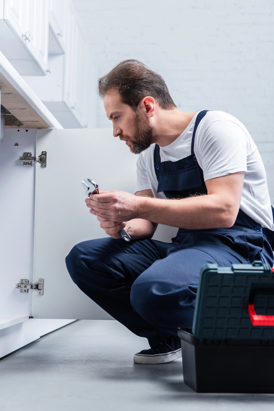 Barryway Plumbing professional working under a sink