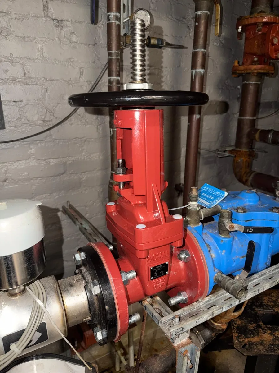 Red handwheel valve on large pipework